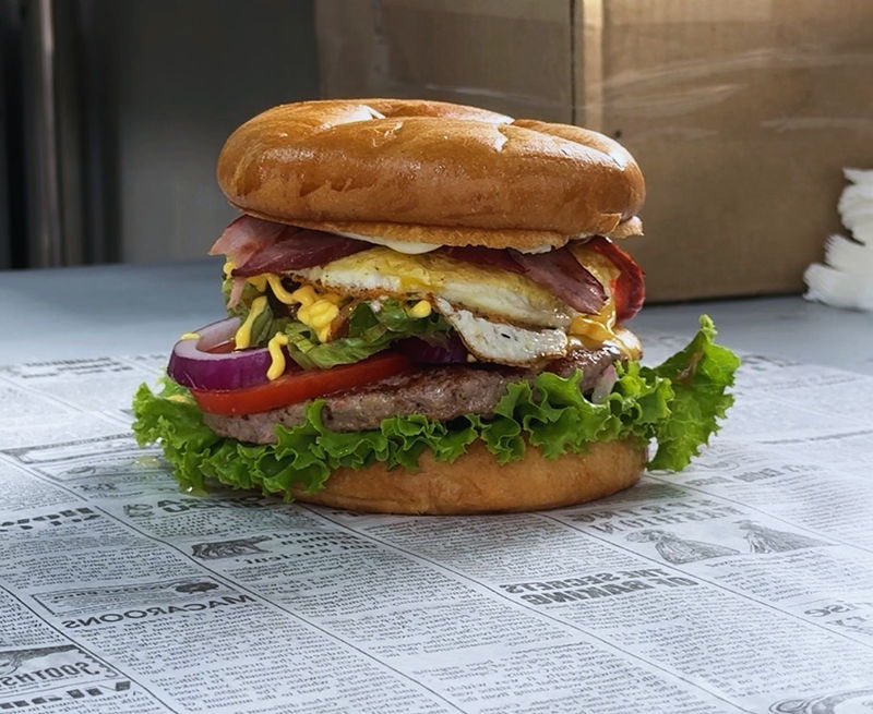 A burger from above on newspaper-print wrap