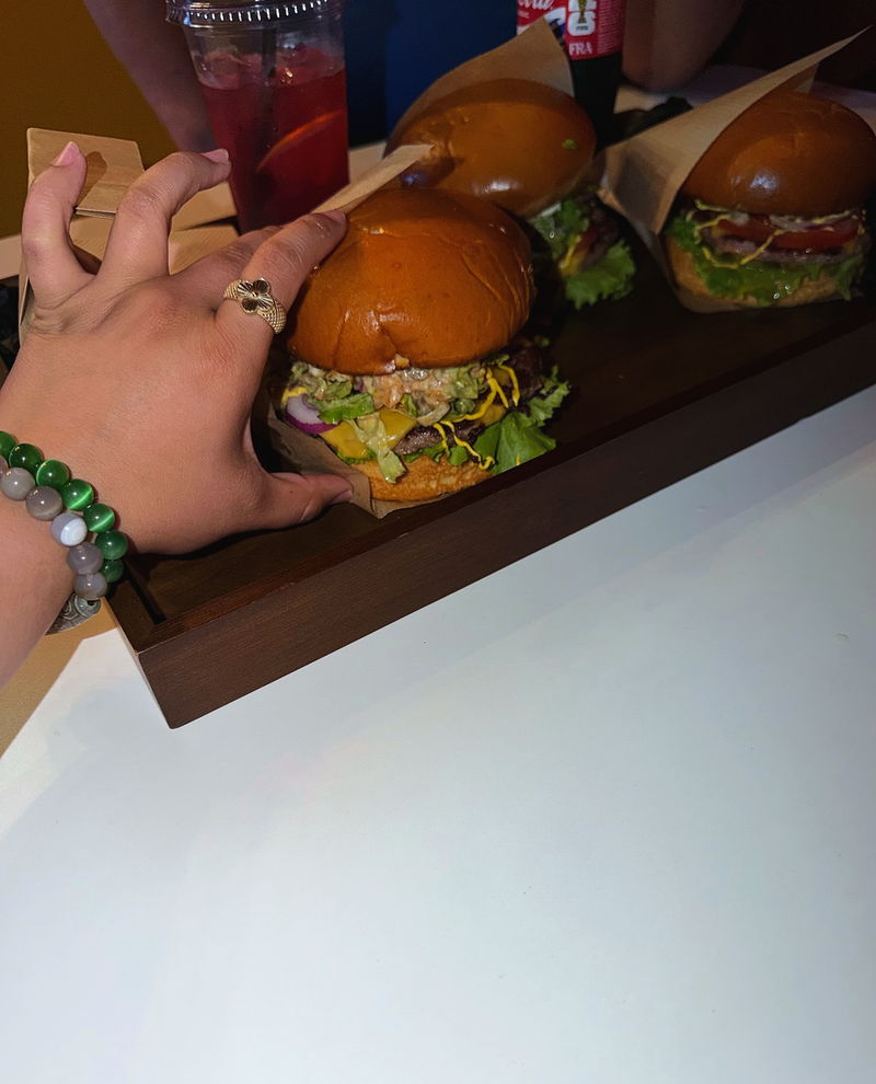 Burgers on a wooden board in the room