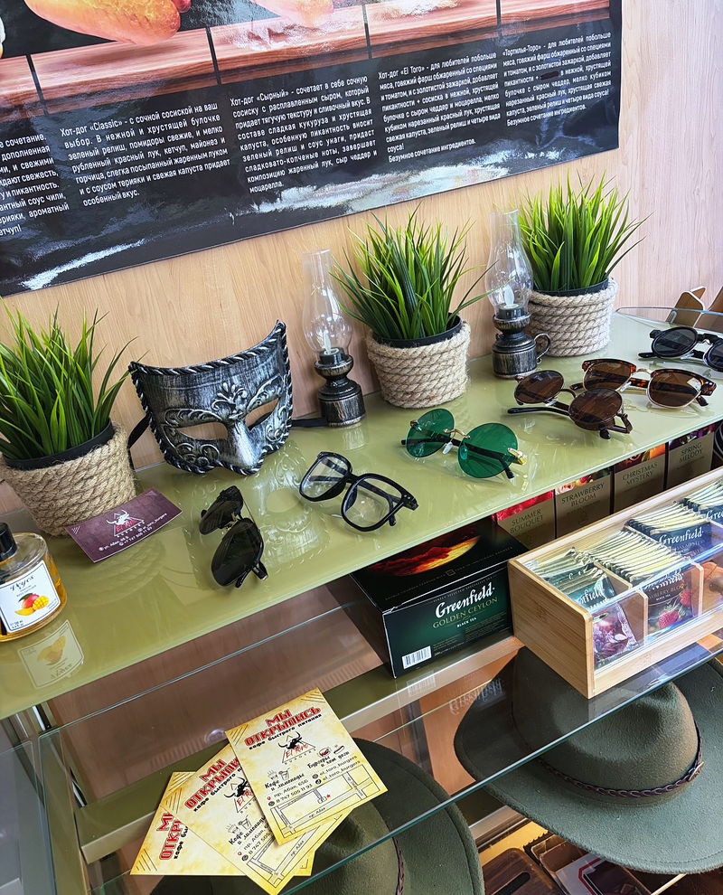 A table with plants and menus by the window